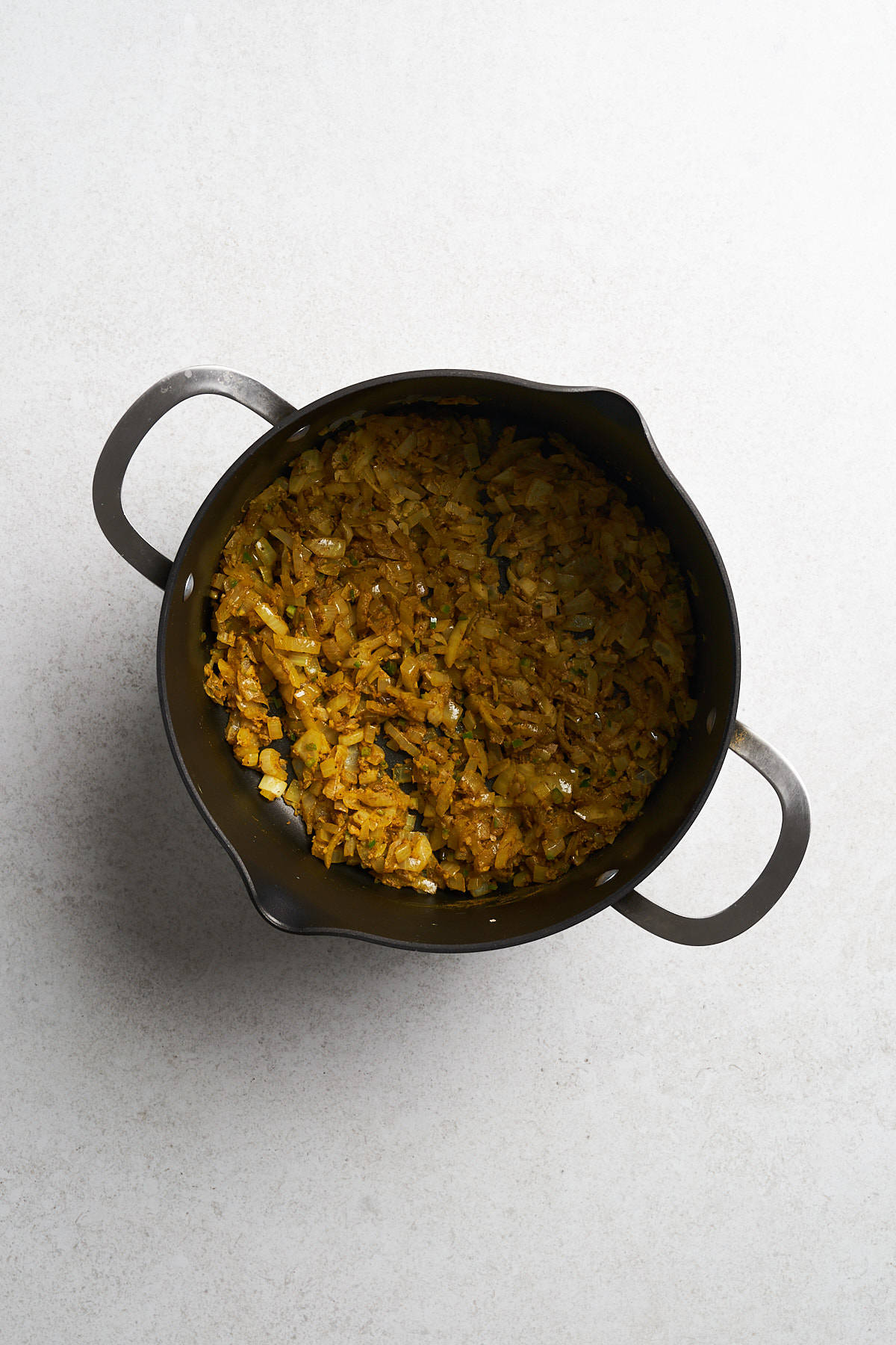 Onions with seasonings in a pot.