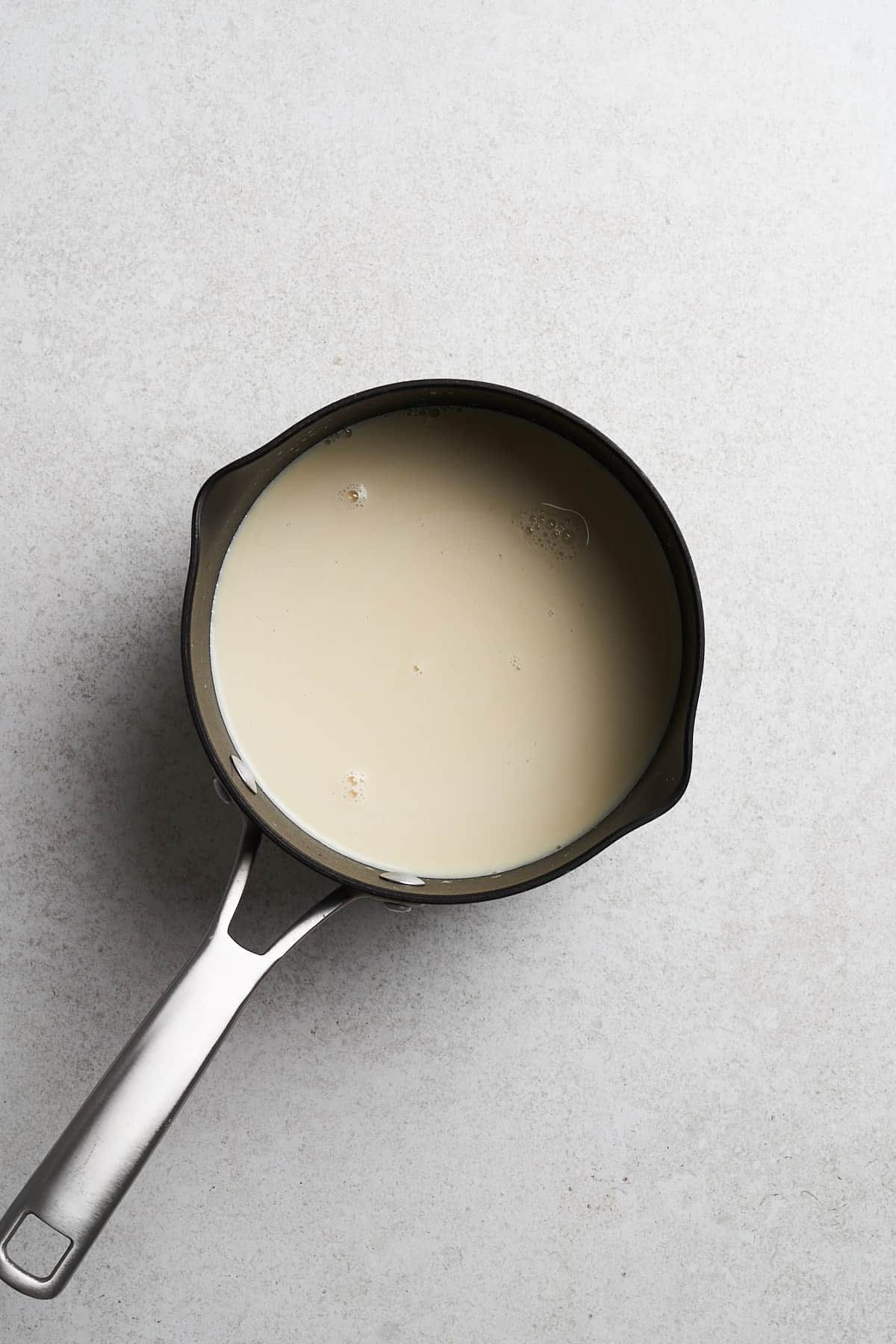 Boiled soymilk in a saucepan.