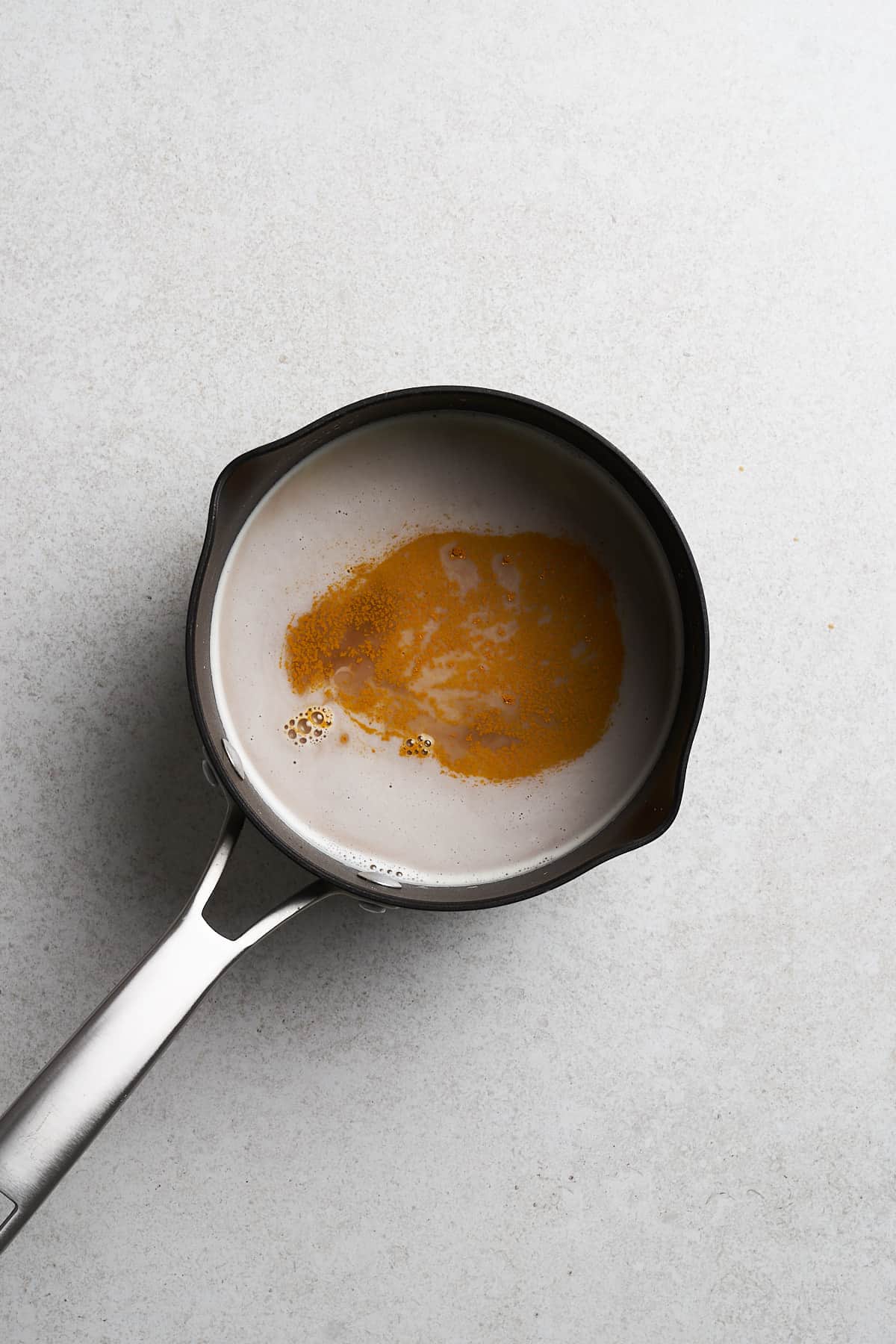 Soymilk and vanilla in a saucepan.