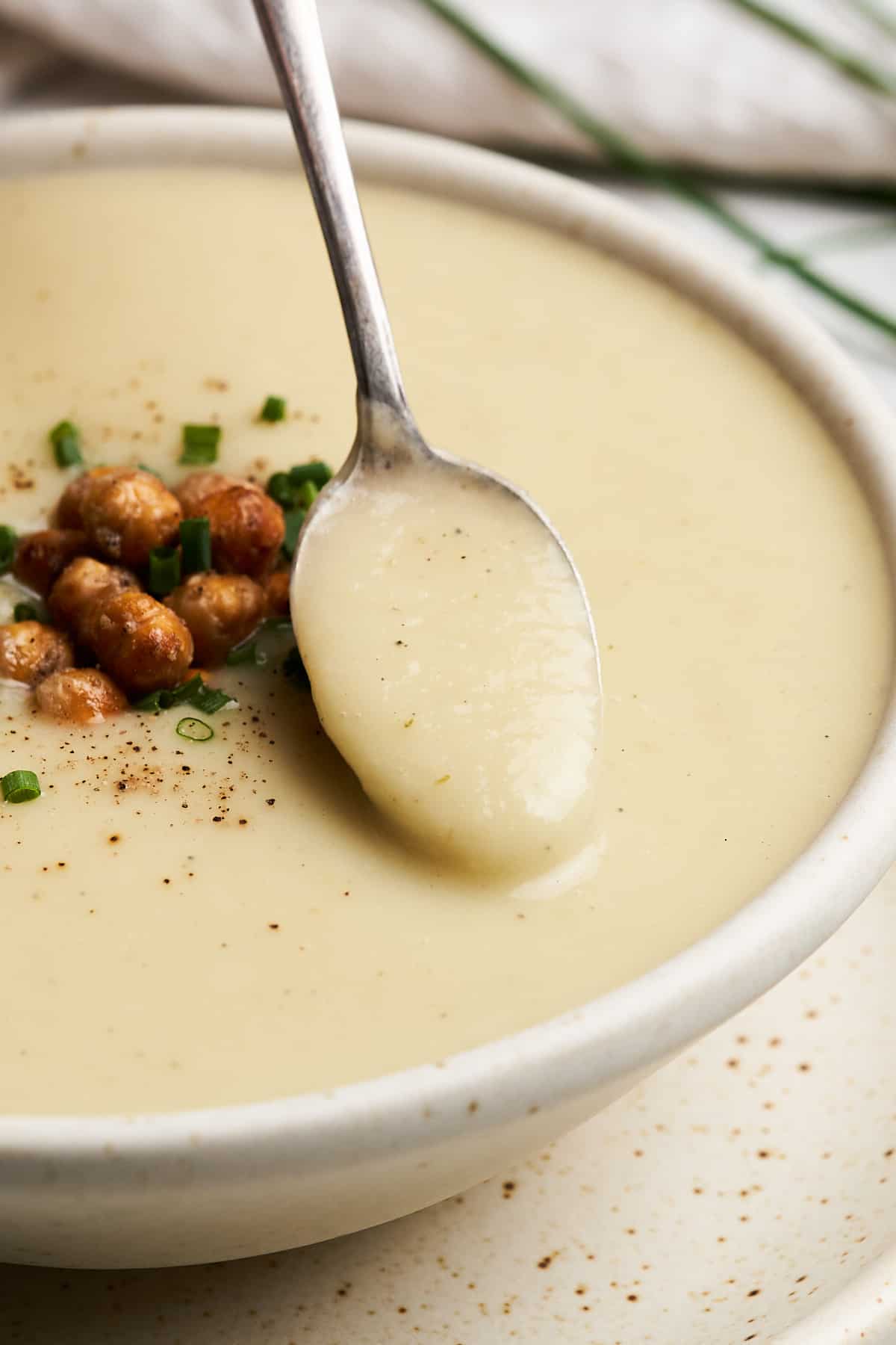 Spoonful of vegan potato leek soup.