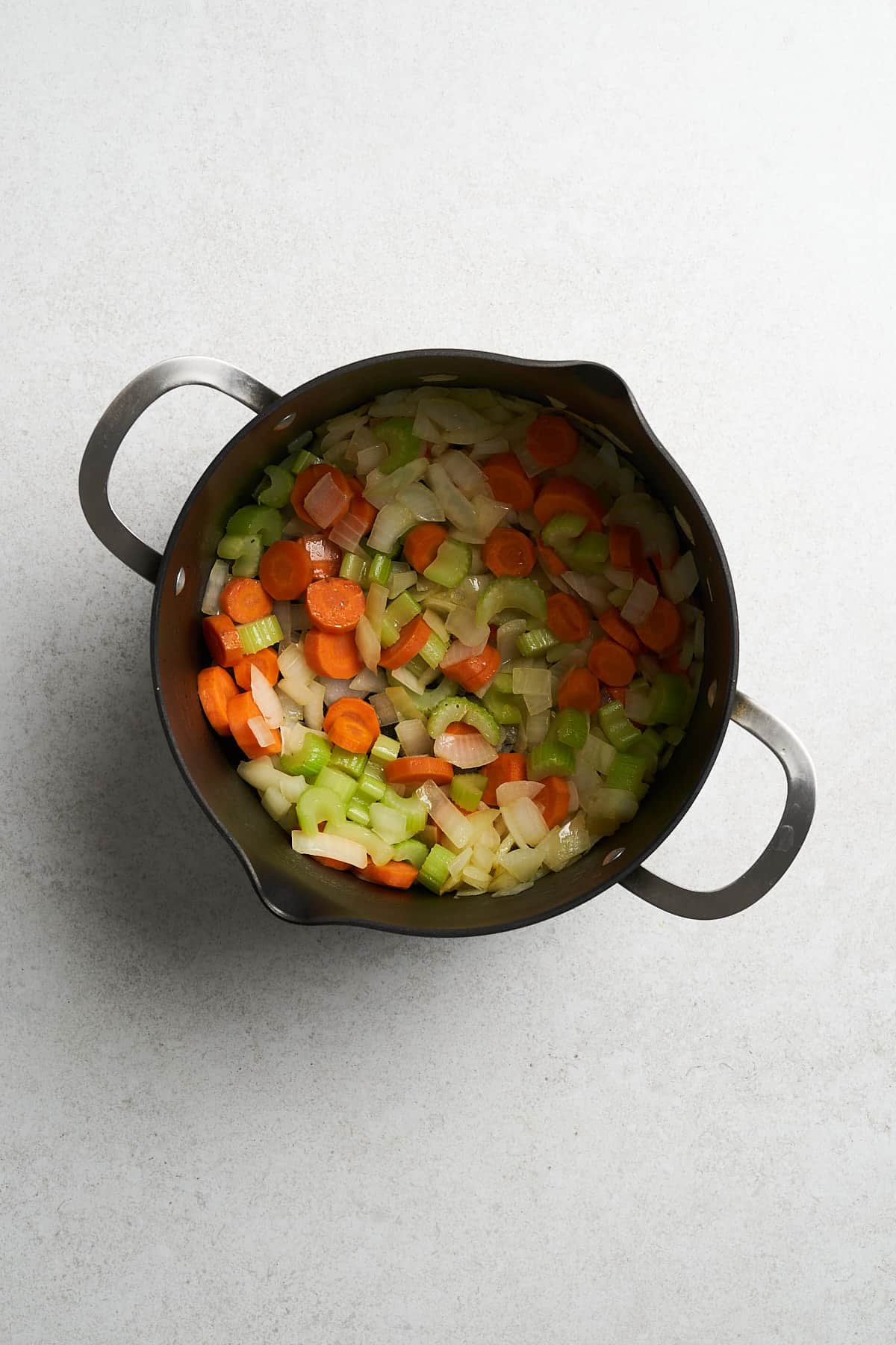 Uncooked garlic, mushrooms and onions in a pot.