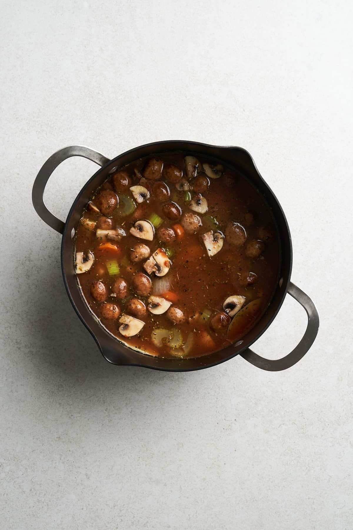 Vegetable broth with other ingredients in a pot.