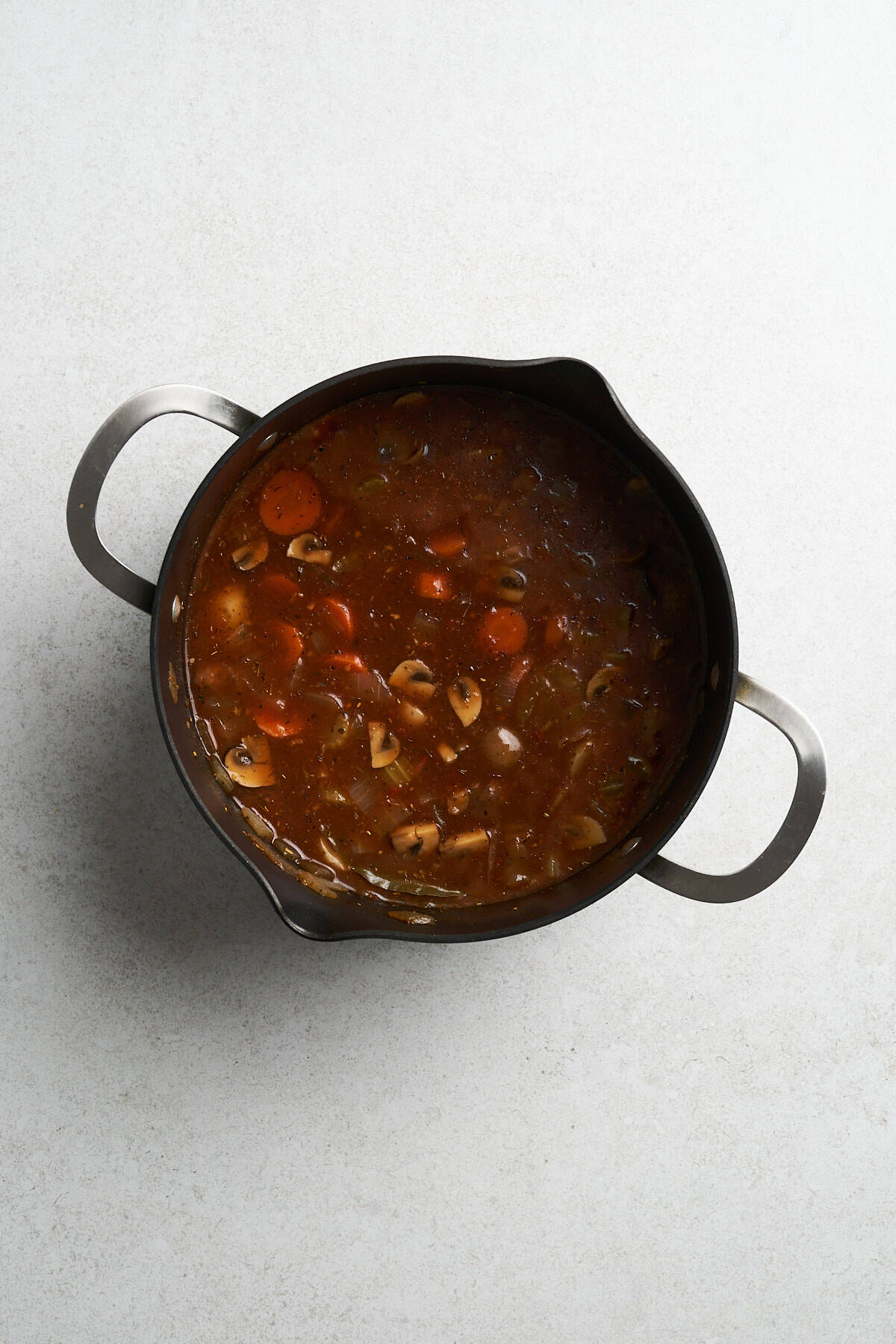 Vegan stew with seasonings in a pot.