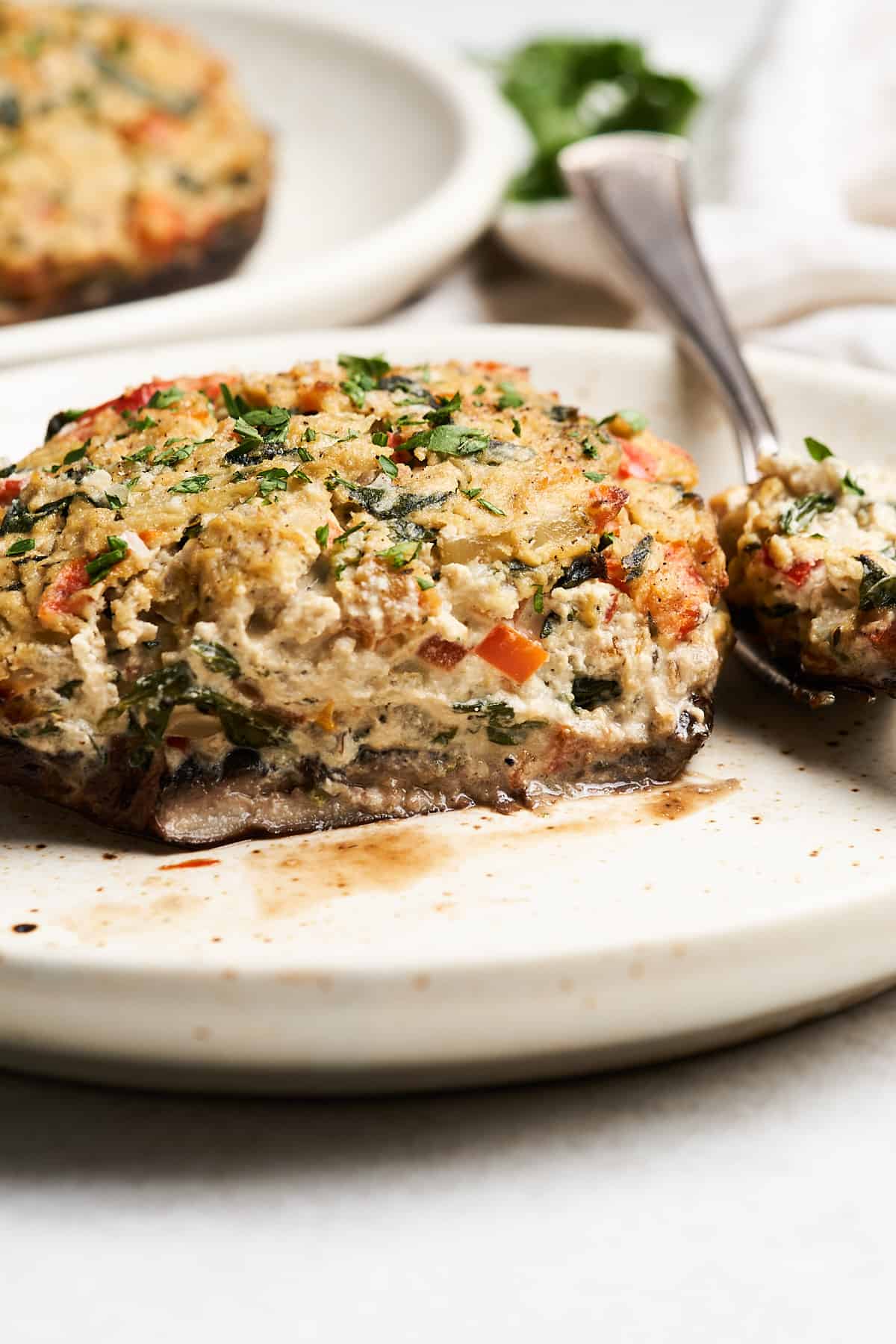 Vegan stuffed portobello mushrooms on a fork.