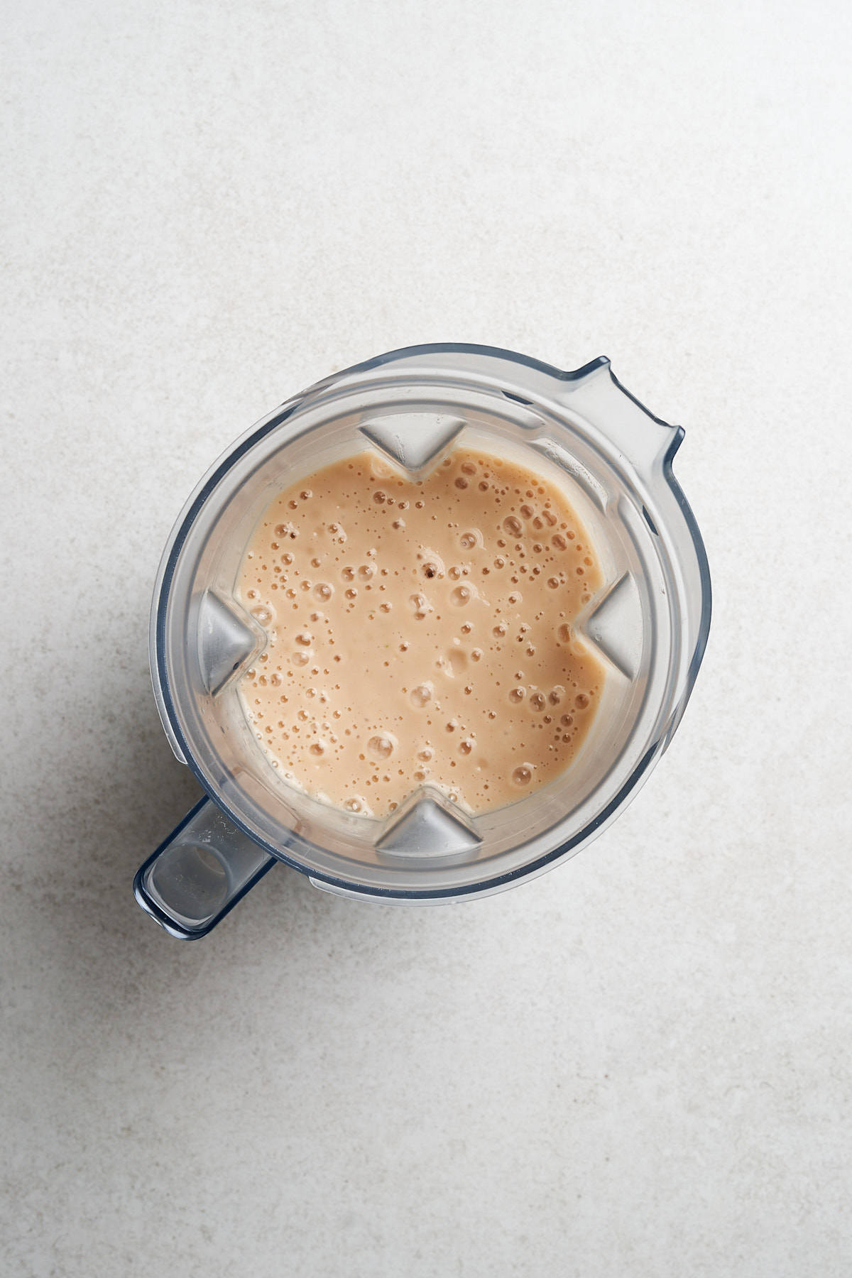 Beans and vegetable broth in a standalone blender.