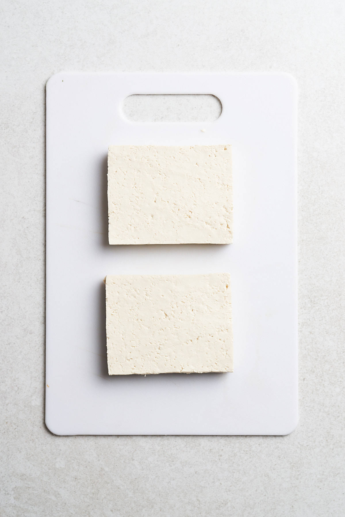 Tofu on a cutting board.