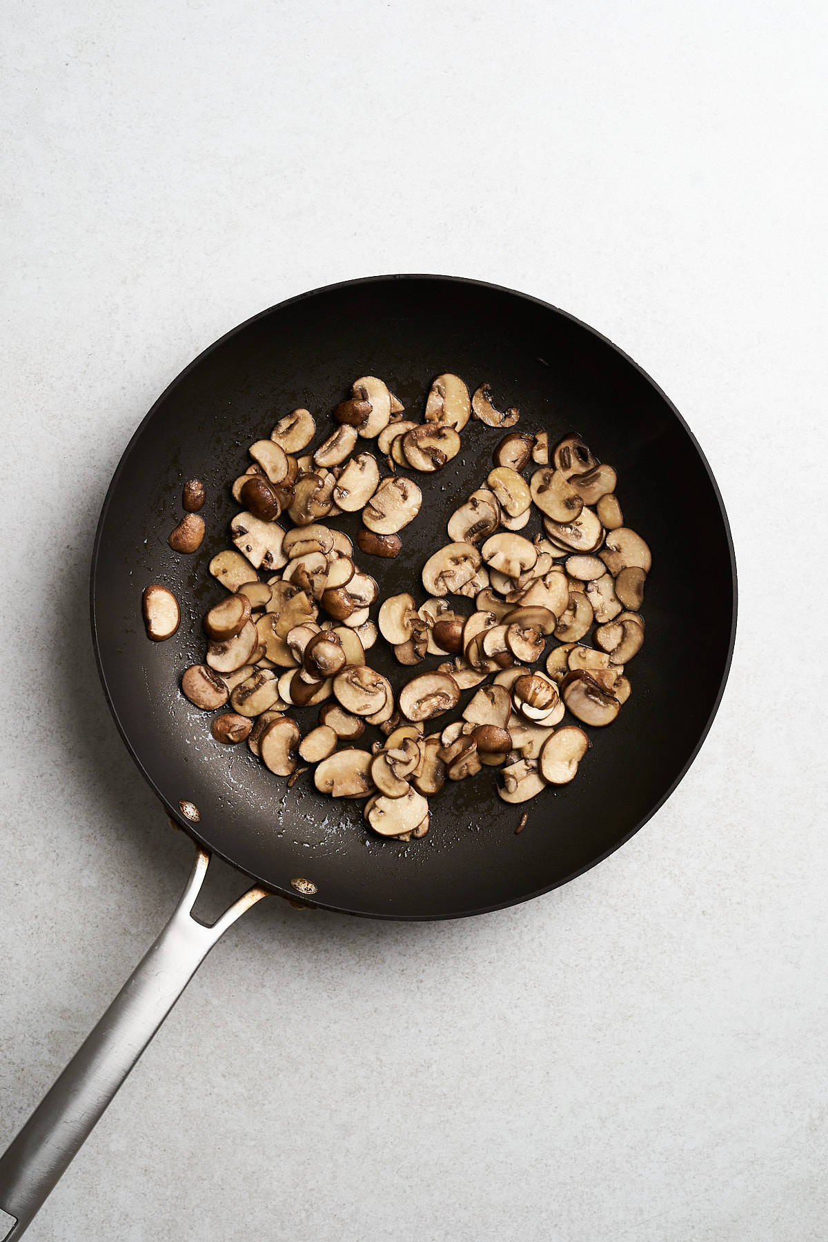 Sliced mushrooms in a skillet.