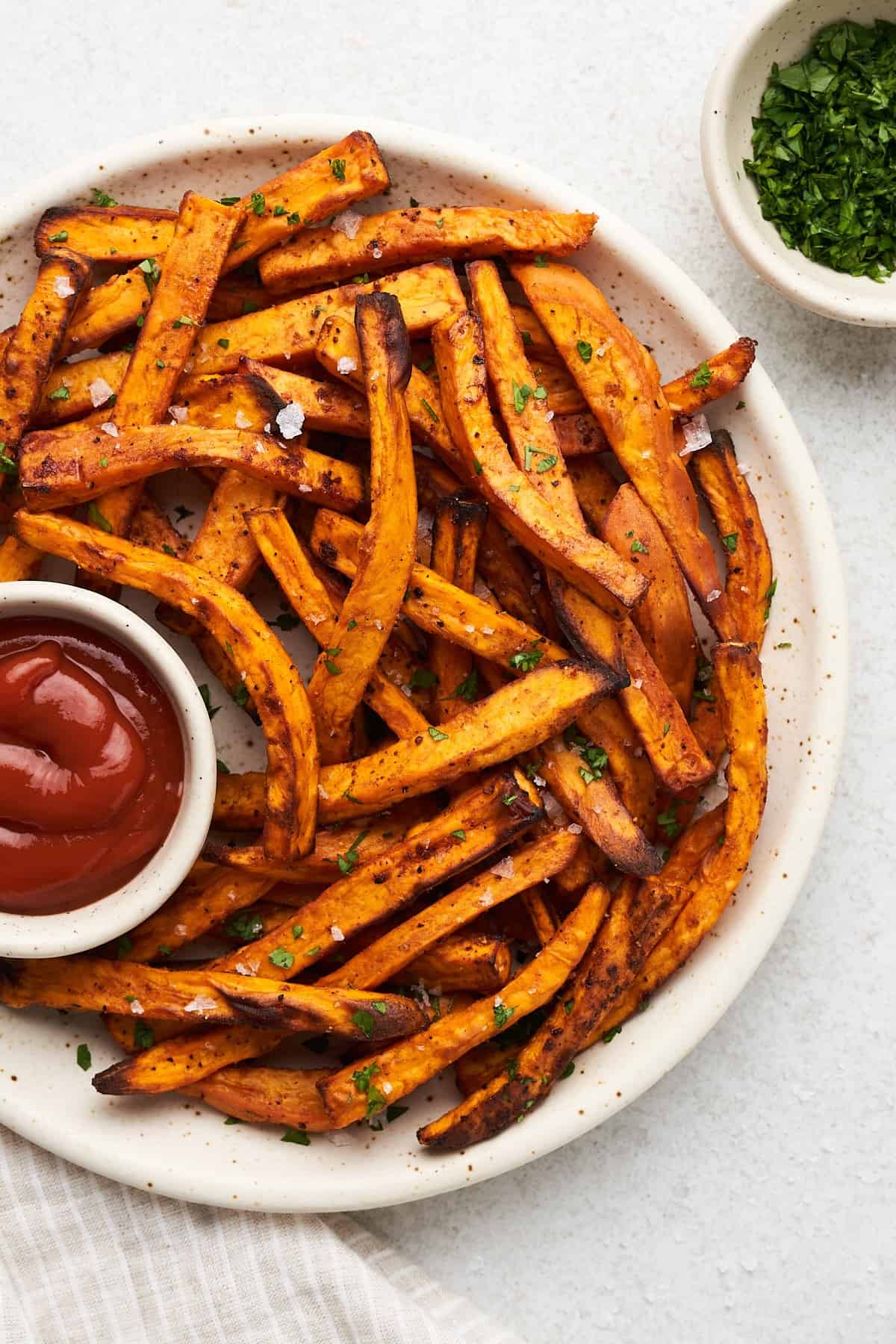 Air fryer sweet potato fries on a plate.