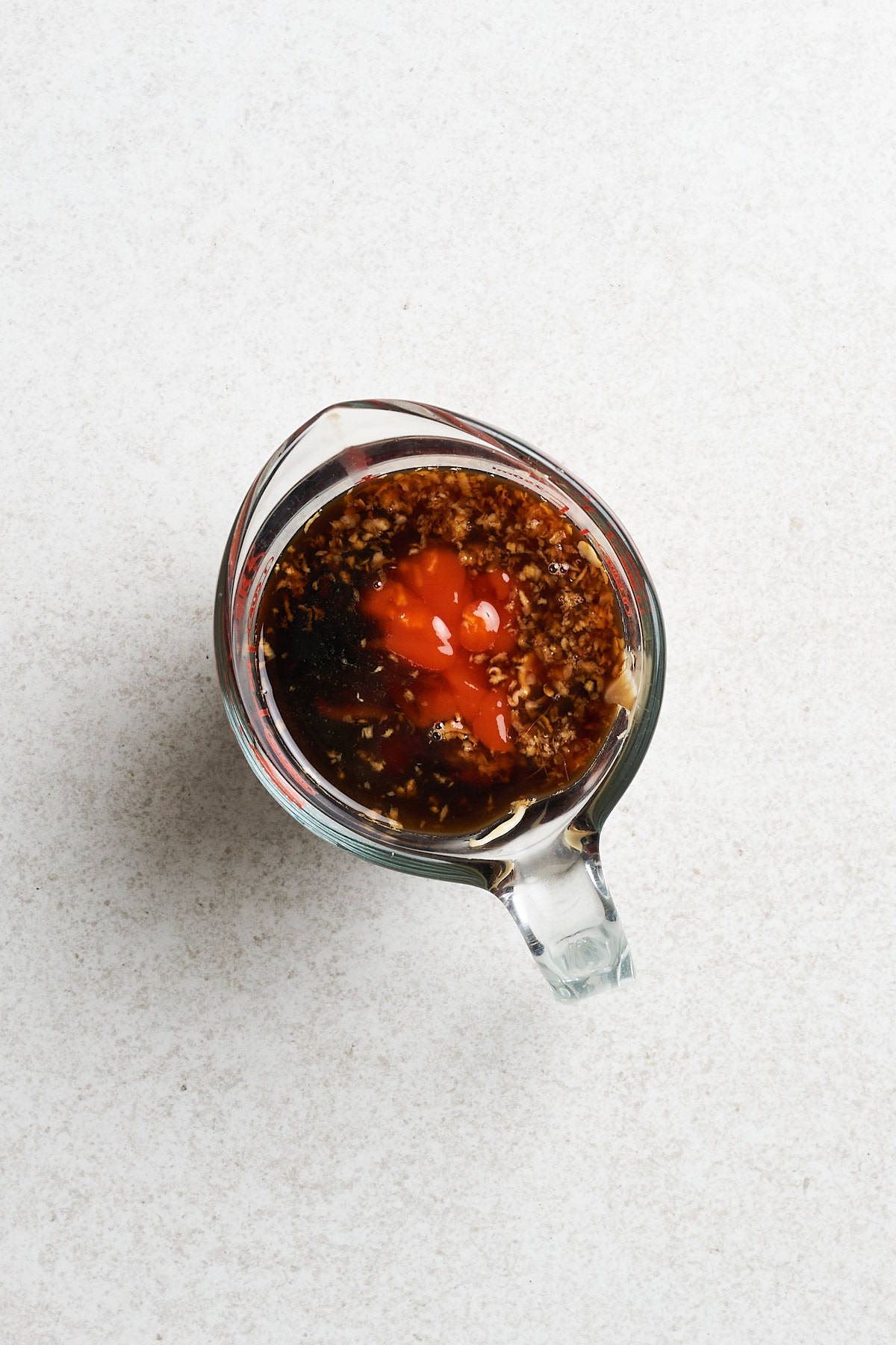 Peanut butter, sriracha and other ingredients in a bowl.