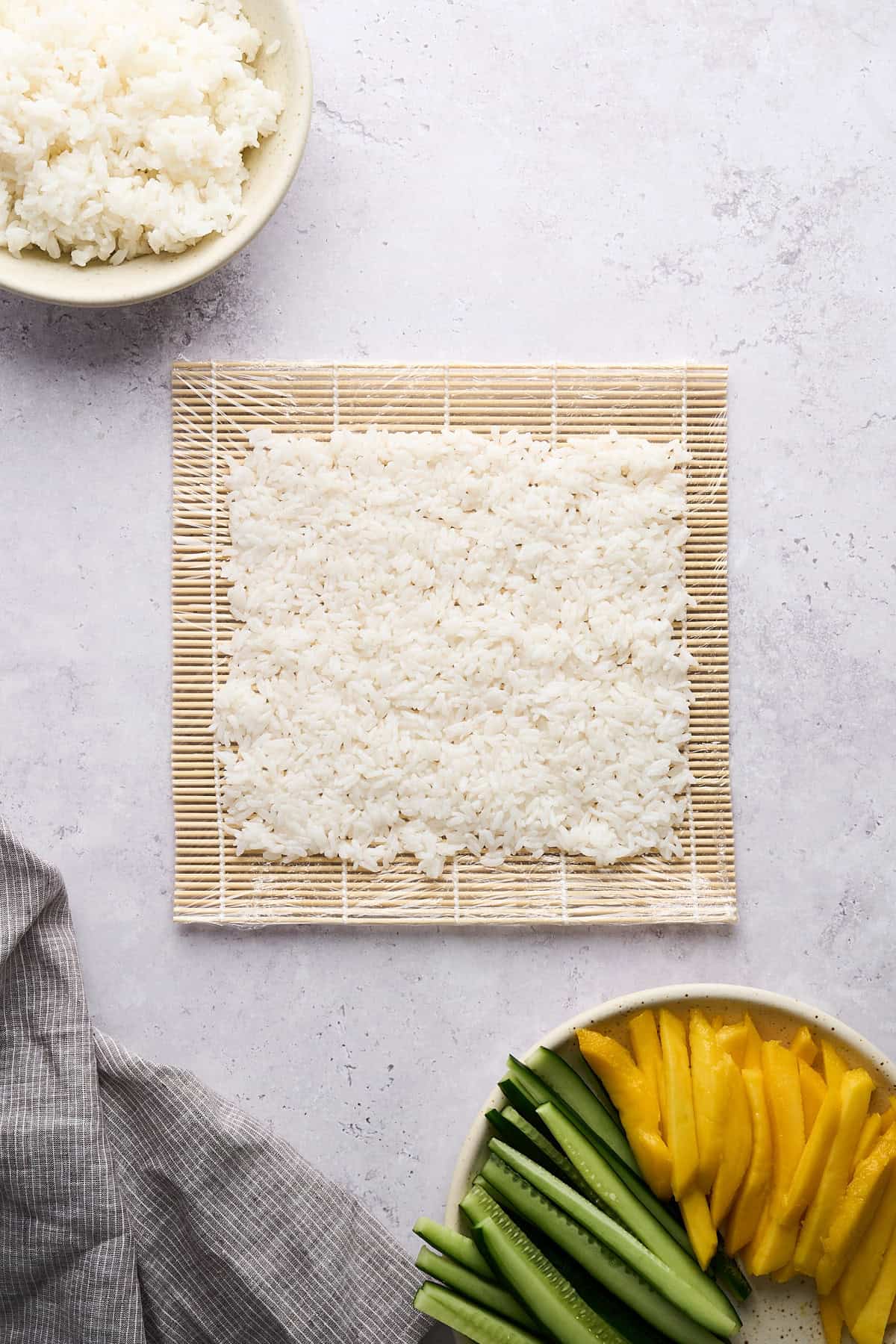 Sushi rice on a bamboo mat.
