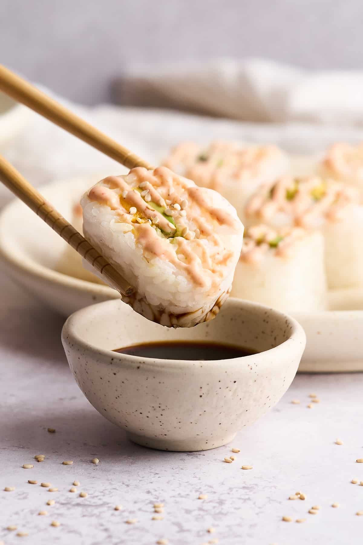 Dipping a piece of sushi in soy sauce.